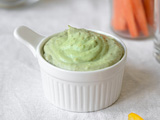 Green dip with veggies on plate