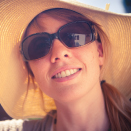woman wearing broad-brimmed hat and sunglasses
