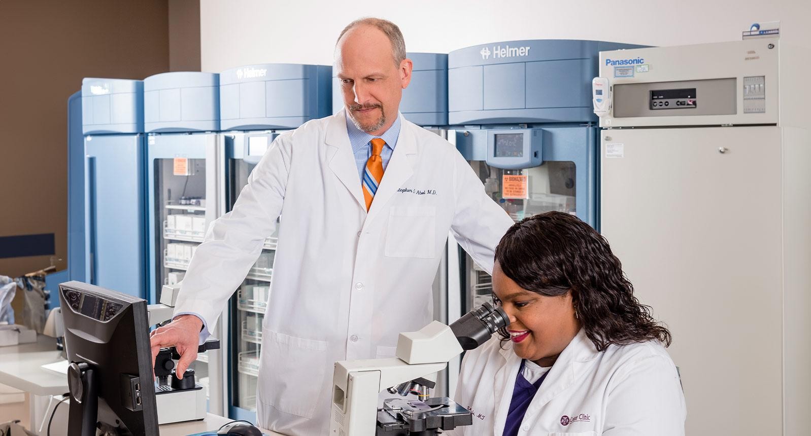 Doctor looking through microscope