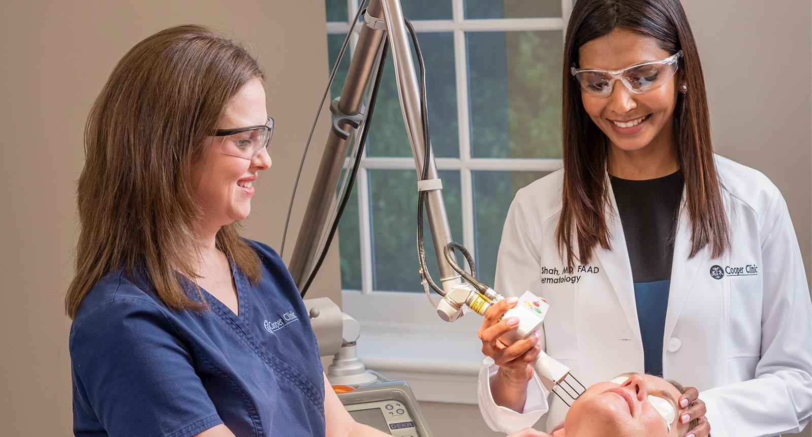 Beautiful woman at the spa getting a facial laser treatment - beauty concepts