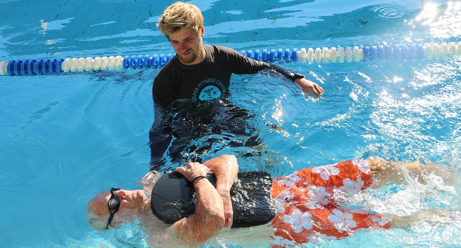 Cooper swim instructor teaching a lesson in a pool