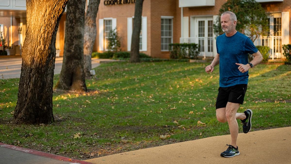 A man taking a run in front of the Cooper Hotel