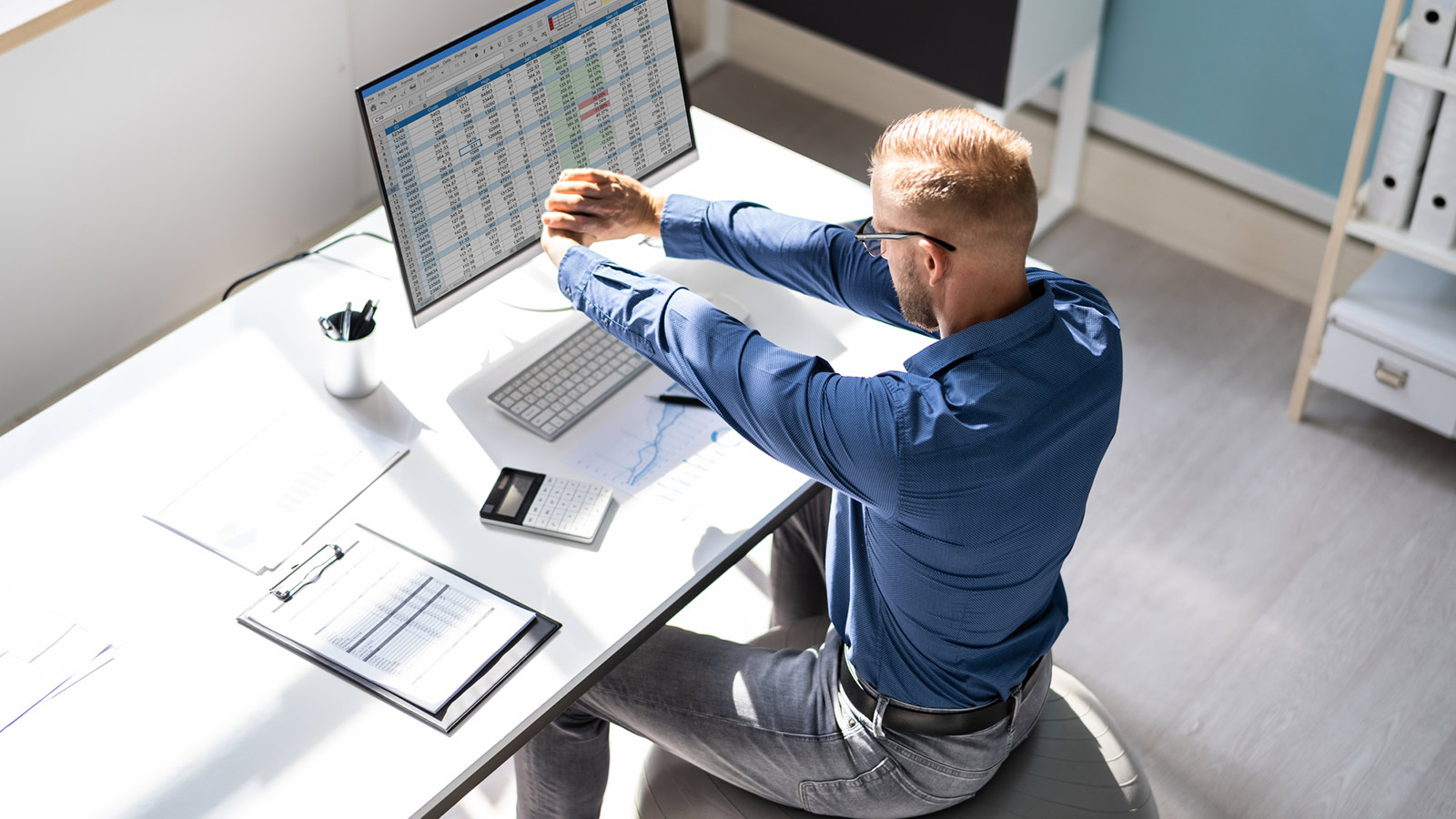 An office employee stretching at work
