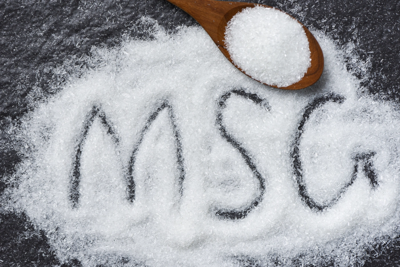MSG on a table with a spoon