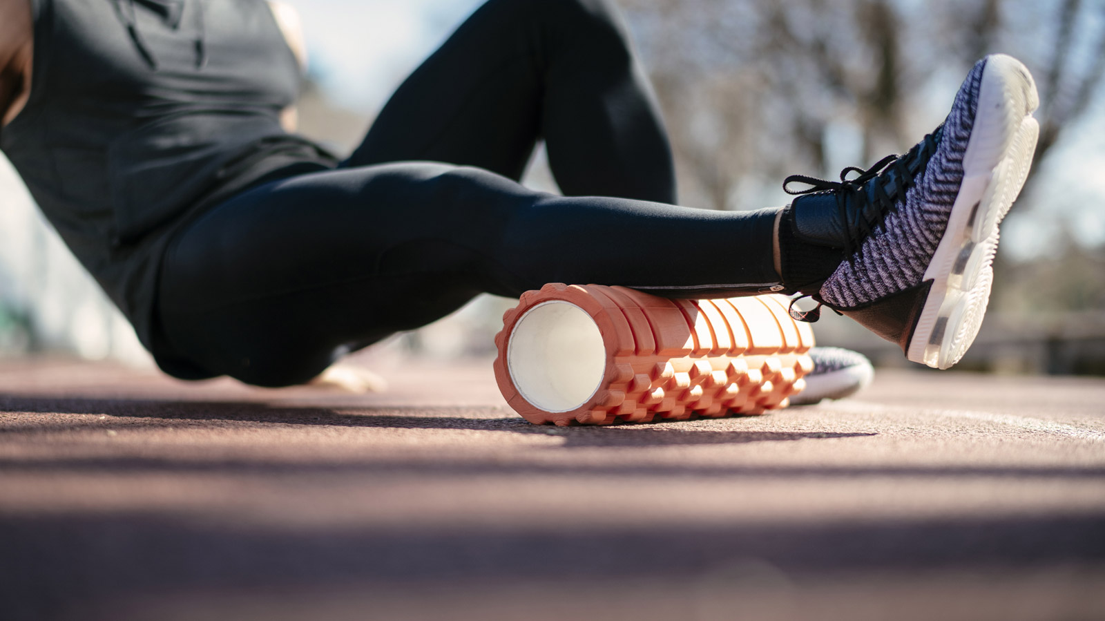 Man using foam roller on his calf muscle