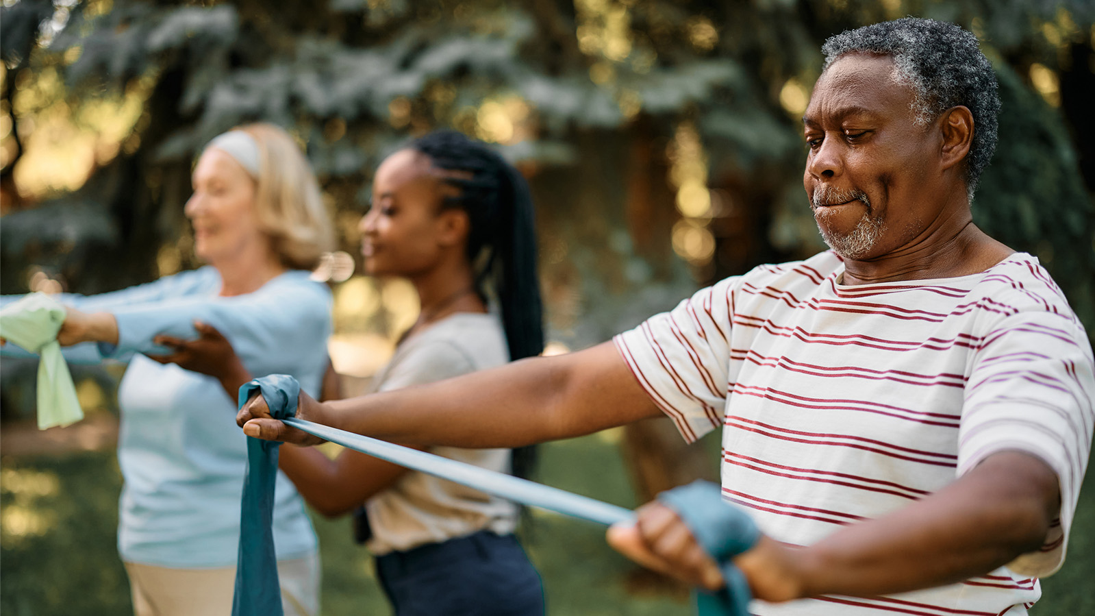 Older generation using arm band strengthening exercise bands
