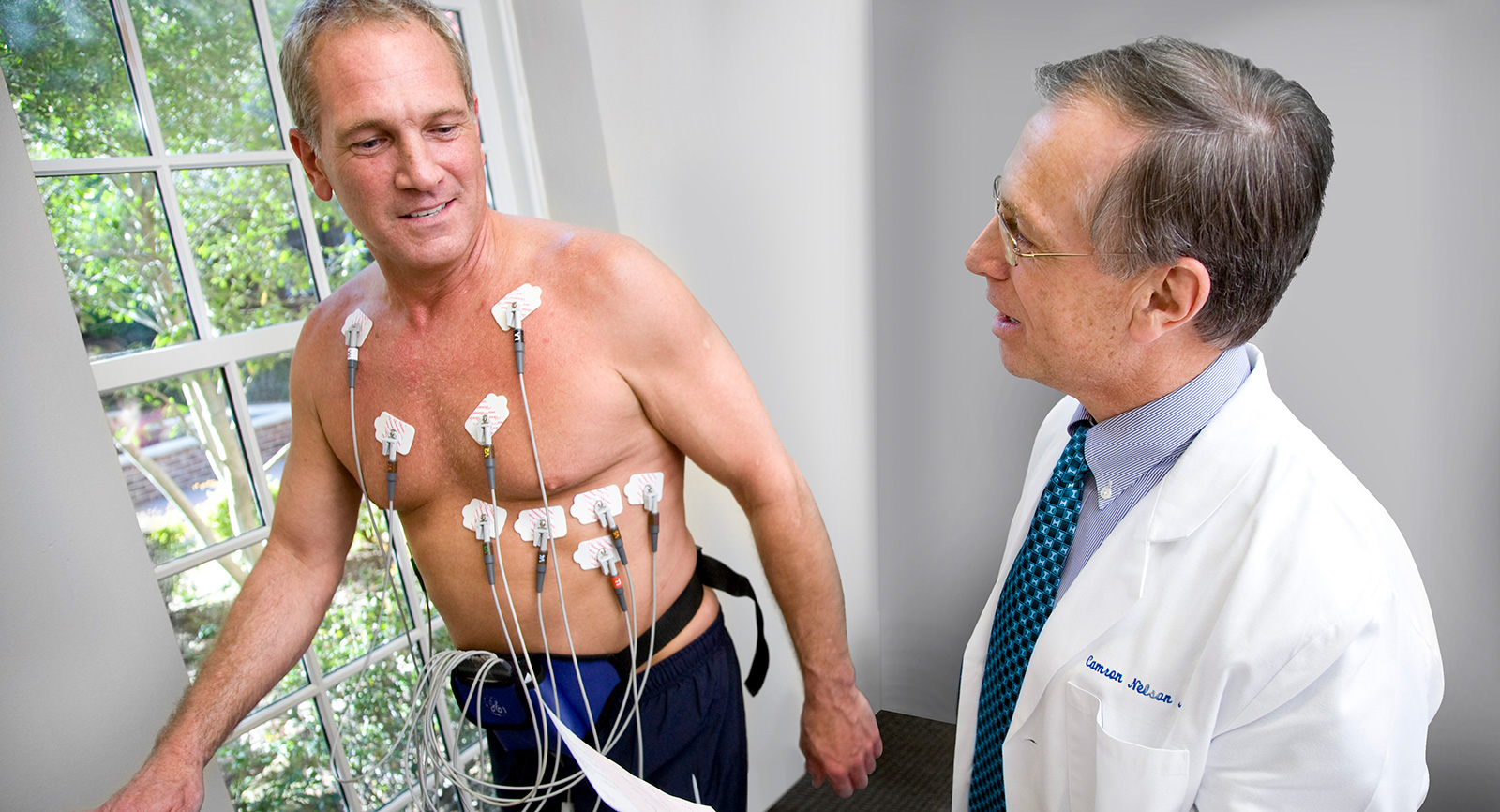 Doctor monitoring patient performing a treadmill stress test
