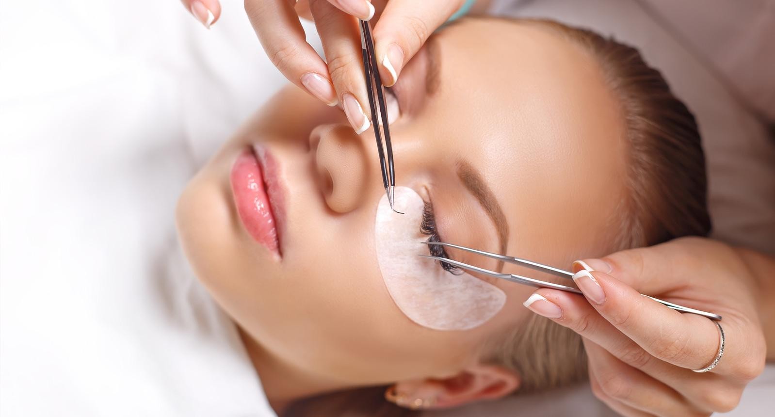 Eyelash Extension Procedure. Woman Eye with Long Eyelashes. Lashes. Close up, selected focus.
