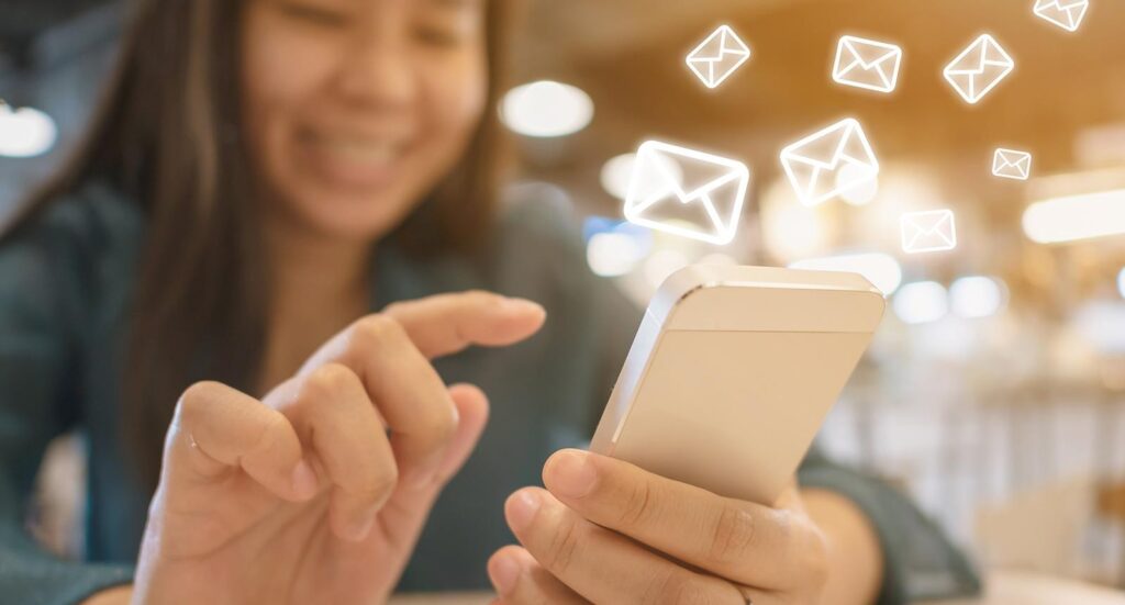 Woman holding a phone and sending a text message