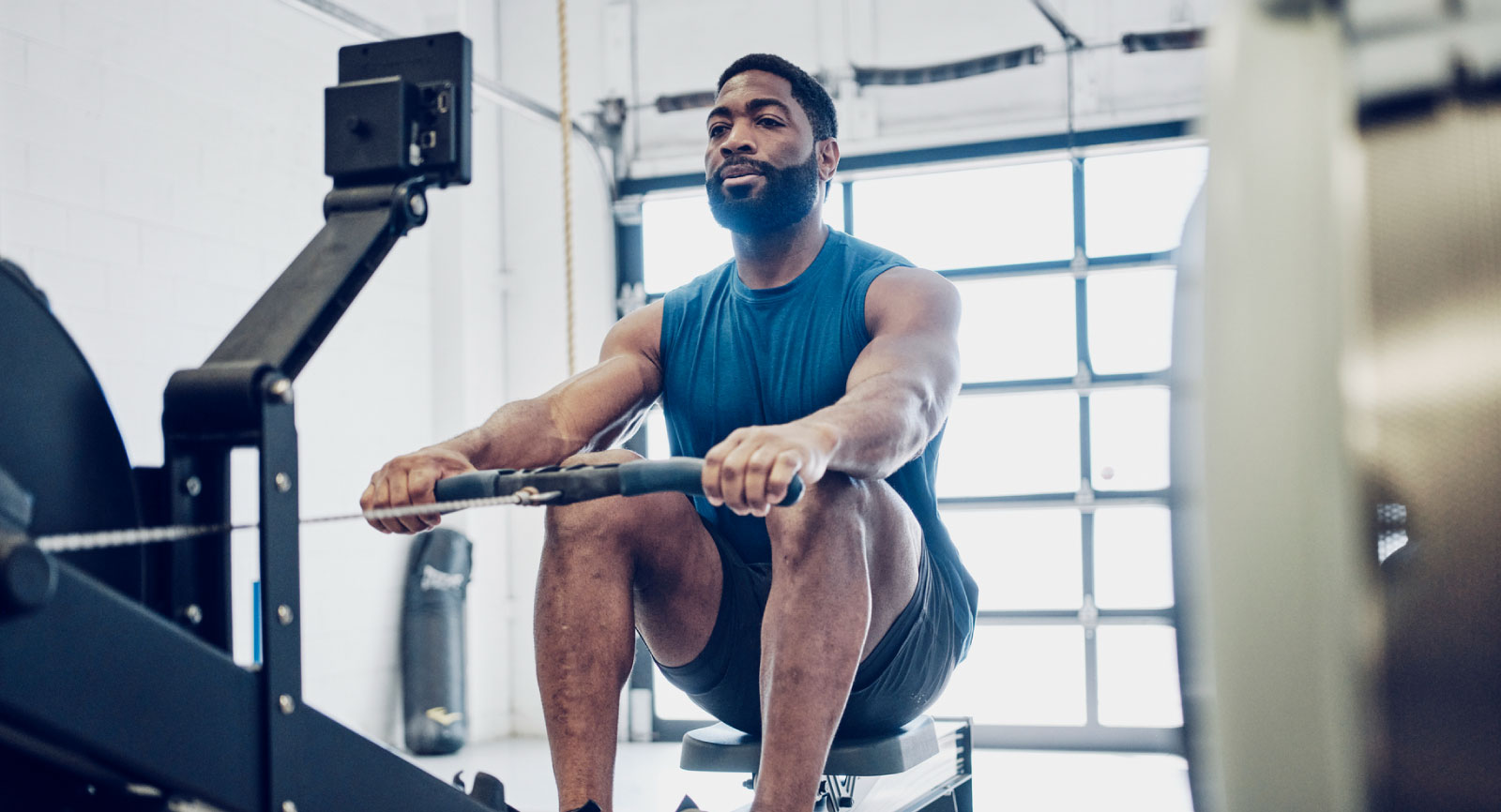 Man on rower exercising.