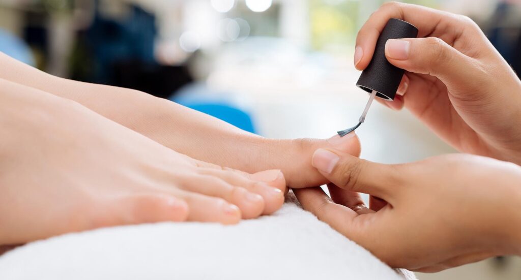 woman getting her toes painted