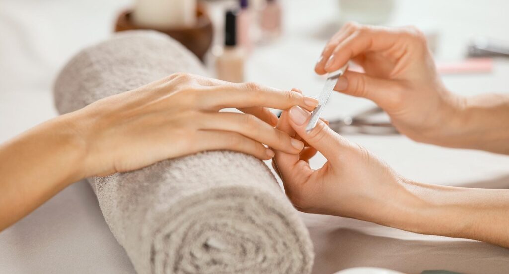 Woman getting manicure