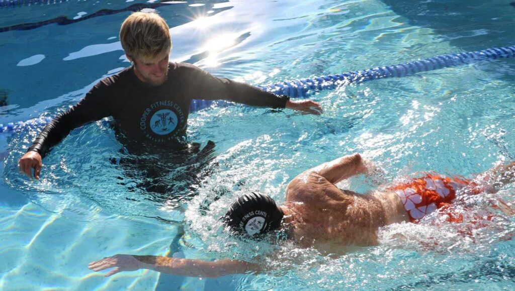 person teaching swim lessons