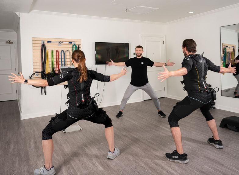 people working out with arms and legs stretched