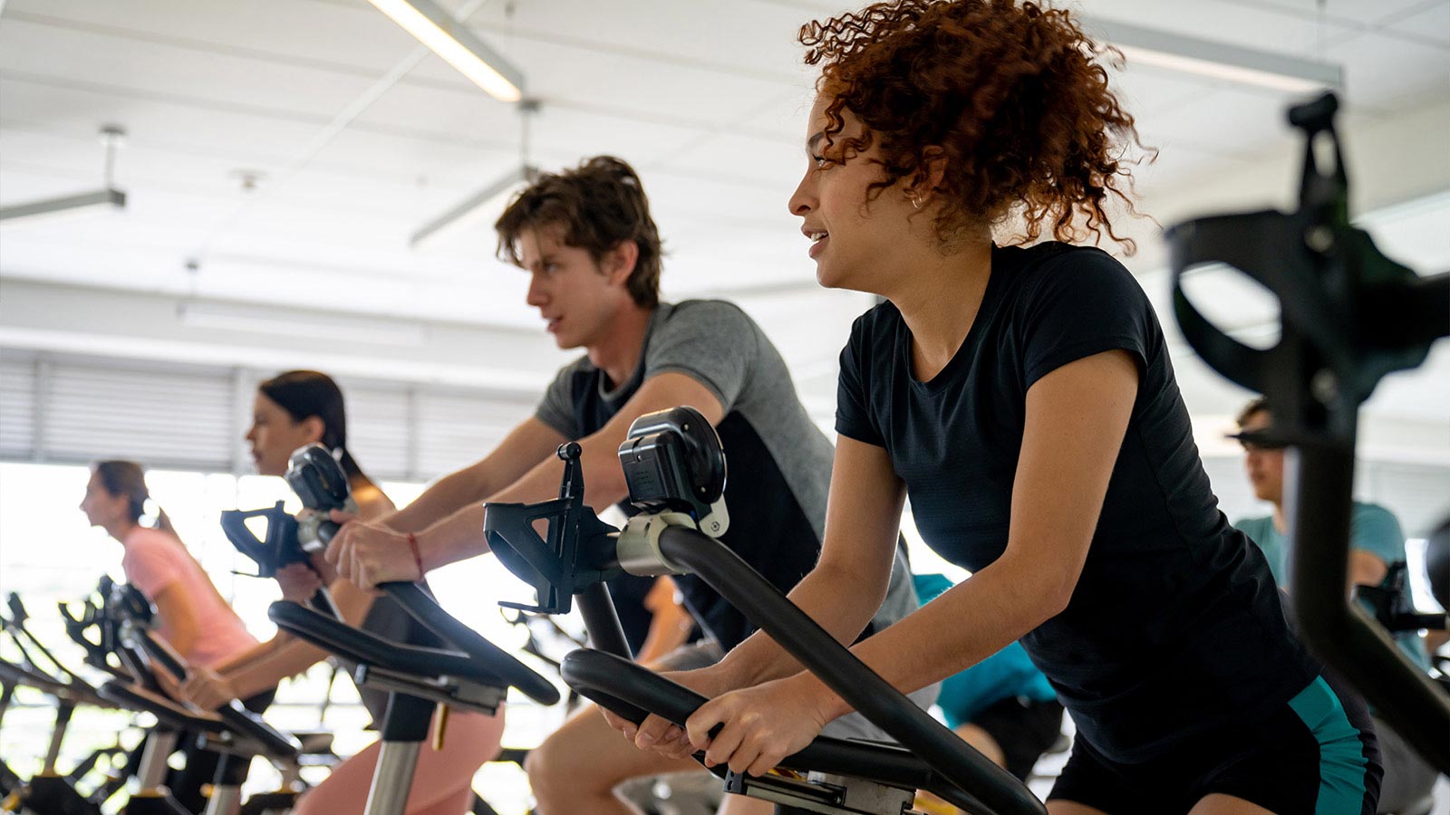 Group of fit people working out in a exercising class - fitness concepts