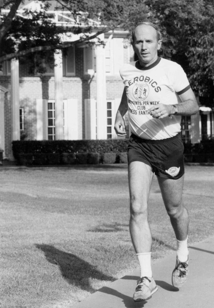 Dr. Kenneth Cooper running in front of the original mansion, currently Cooper Fitness Center, 1980s