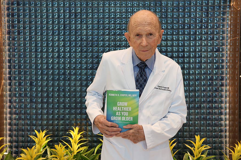 Dr. Cooper holding book