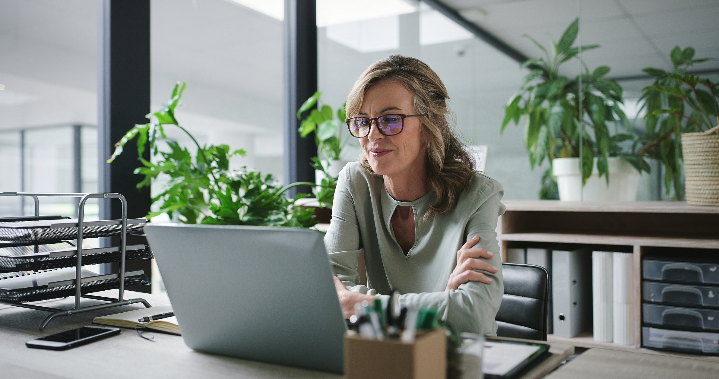 Mature woman working at desk on laptop